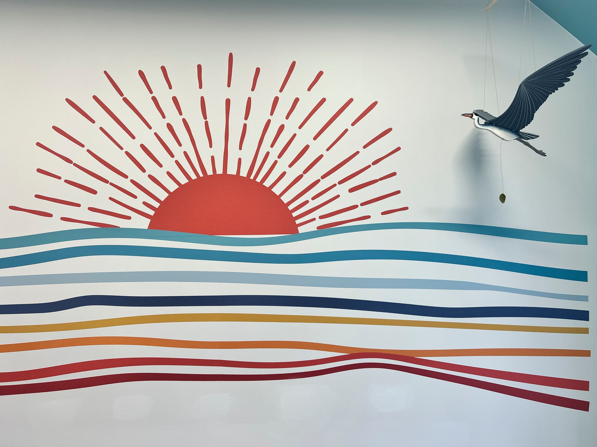 A painting of a sunset over the ocean with a bird flying in the background