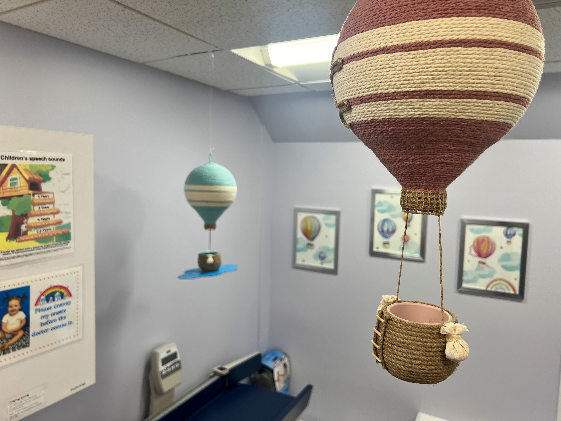 A room with hot air balloons hanging from the ceiling