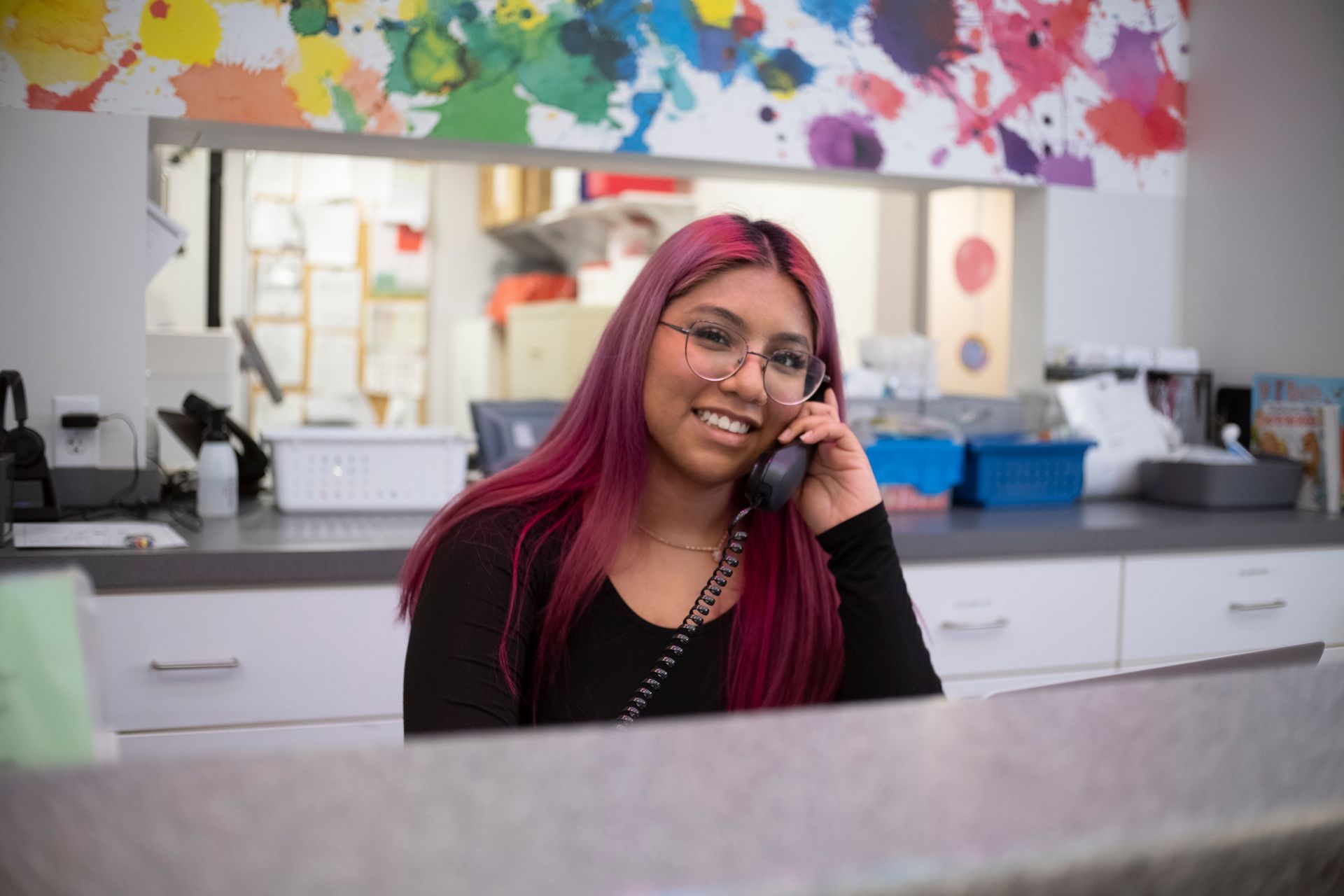 Smiling receptionist answering a phone call