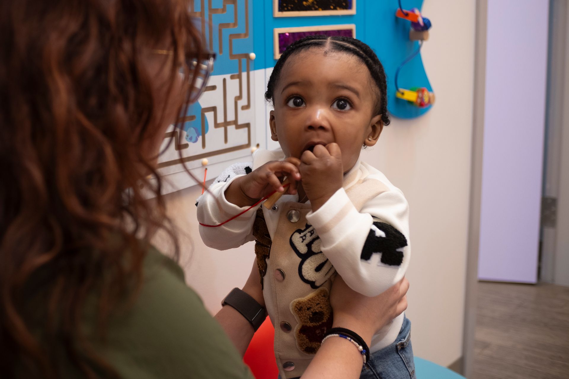 A woman is holding a little girl in her arms.