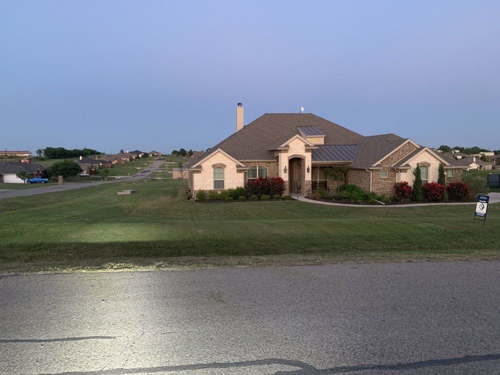 A house with a for sale sign in front of it