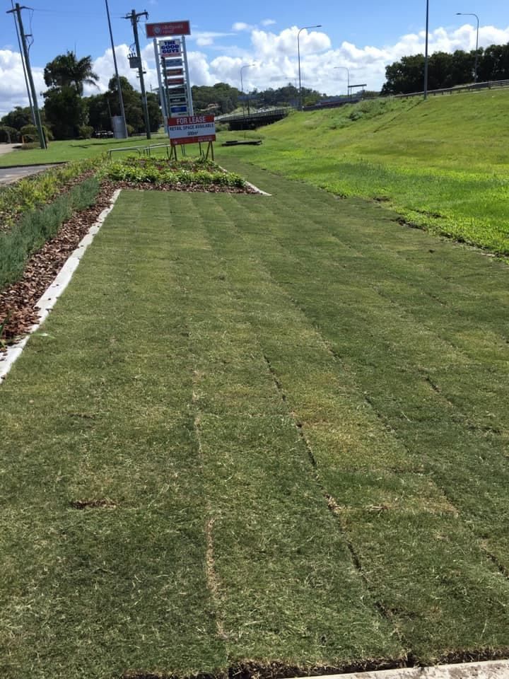 A Lush Green Field of Grass With a Gas Station Sign in the Background — Turf Central In Chelona, QLD