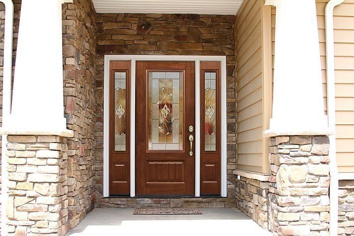 A brown front door with glass