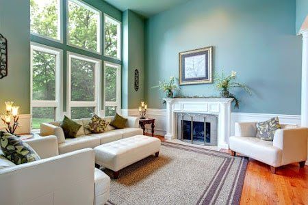 a luxury living room with white furniture and a large exterior window