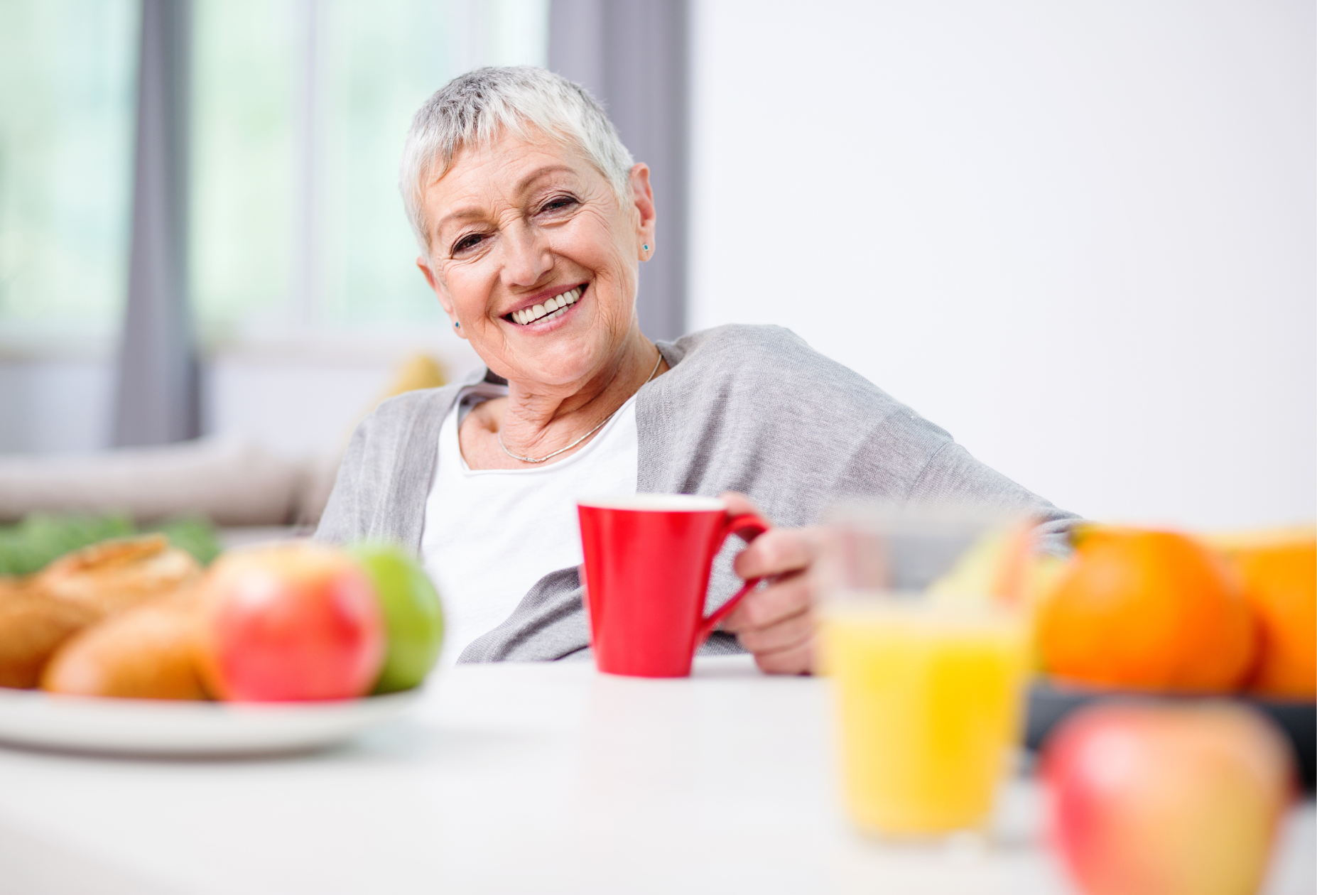 A man and a woman are sitting on a couch talking to each other.