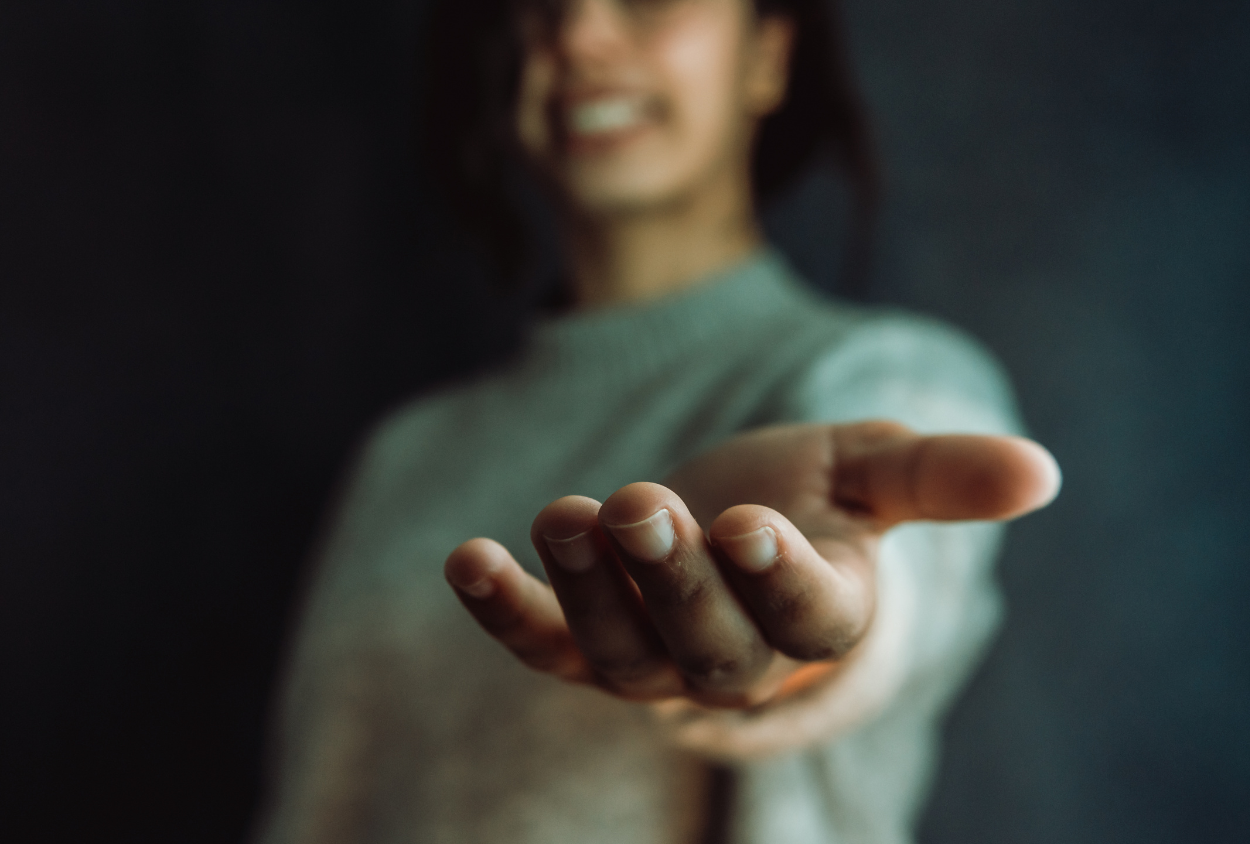 A man is sitting on a couch using a laptop computer.