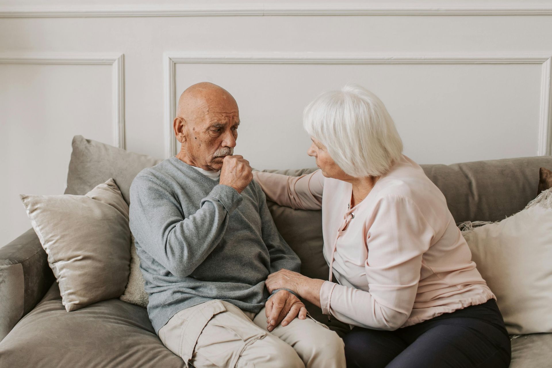 A man is coughing while holding a stuffed lung.
