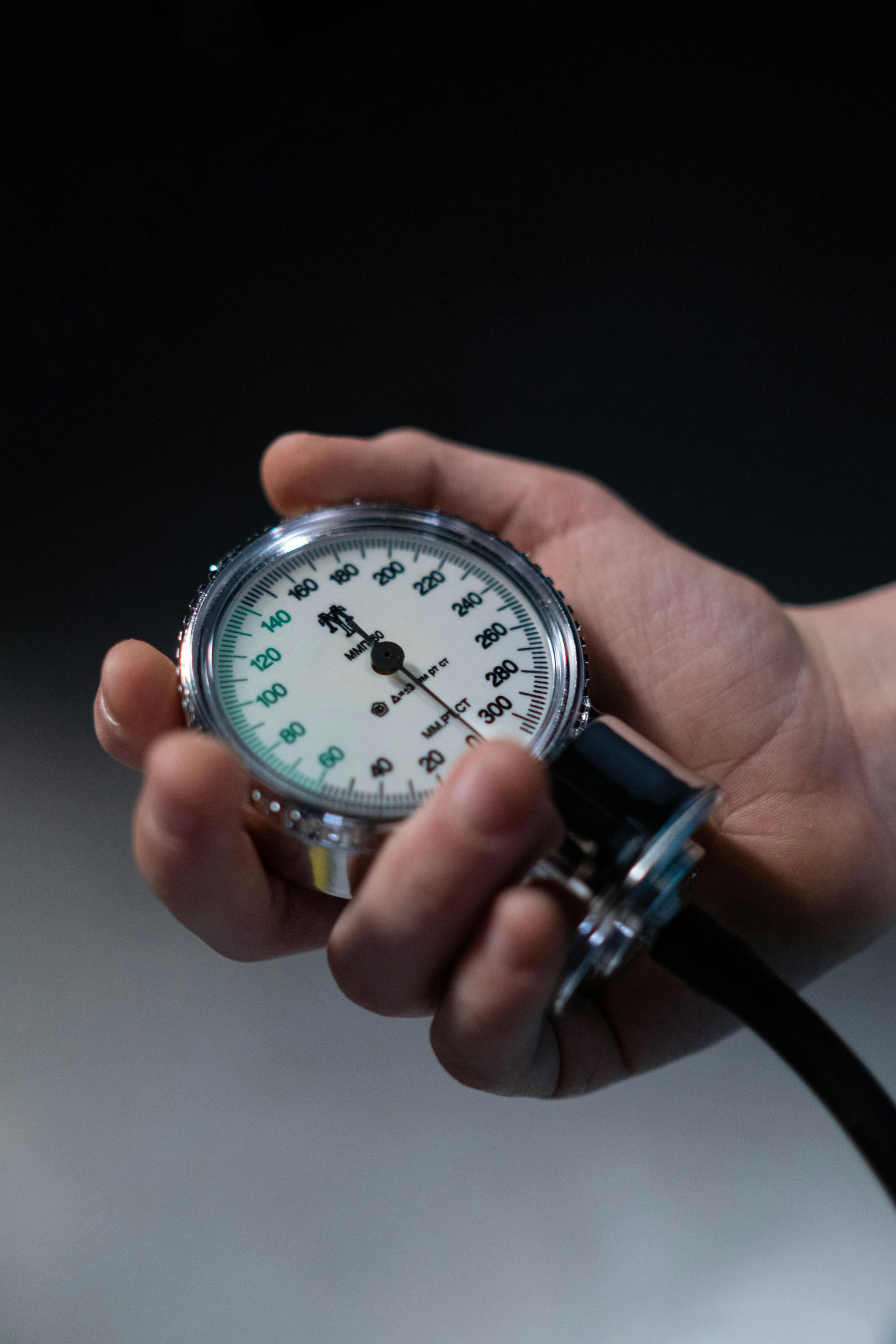 A person is holding a pressure gauge in their hand.