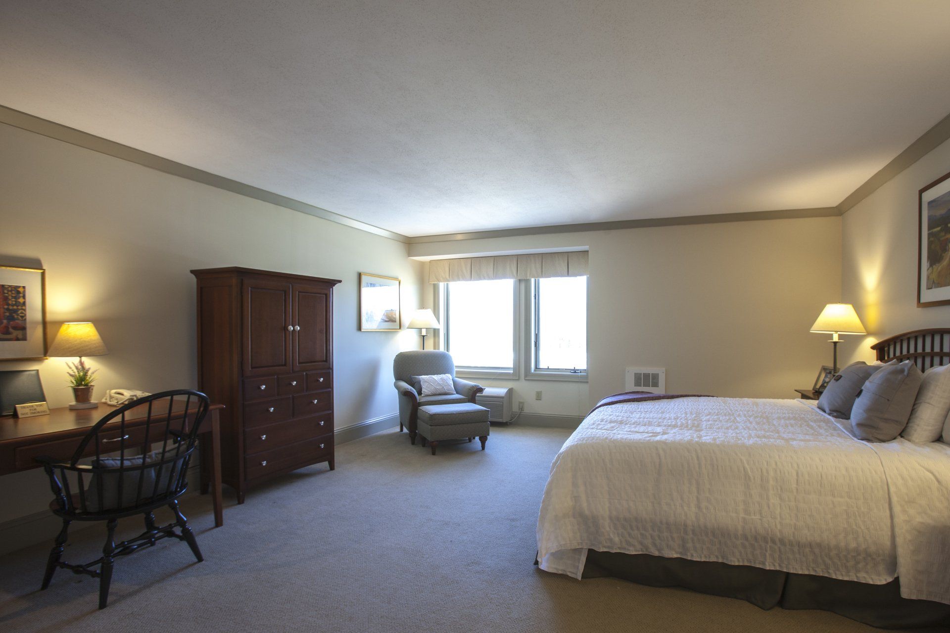 The desk, TV hutch and chair with ottoman in the Lilac Room.