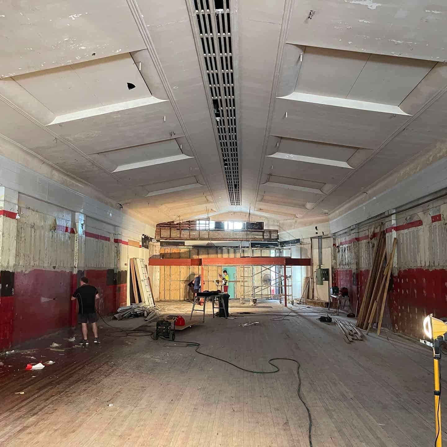 A Large Empty Room With Wooden Floors and a Vaulted Ceiling — JIC Projects Pty Ltd in Runaway Bay, QLD