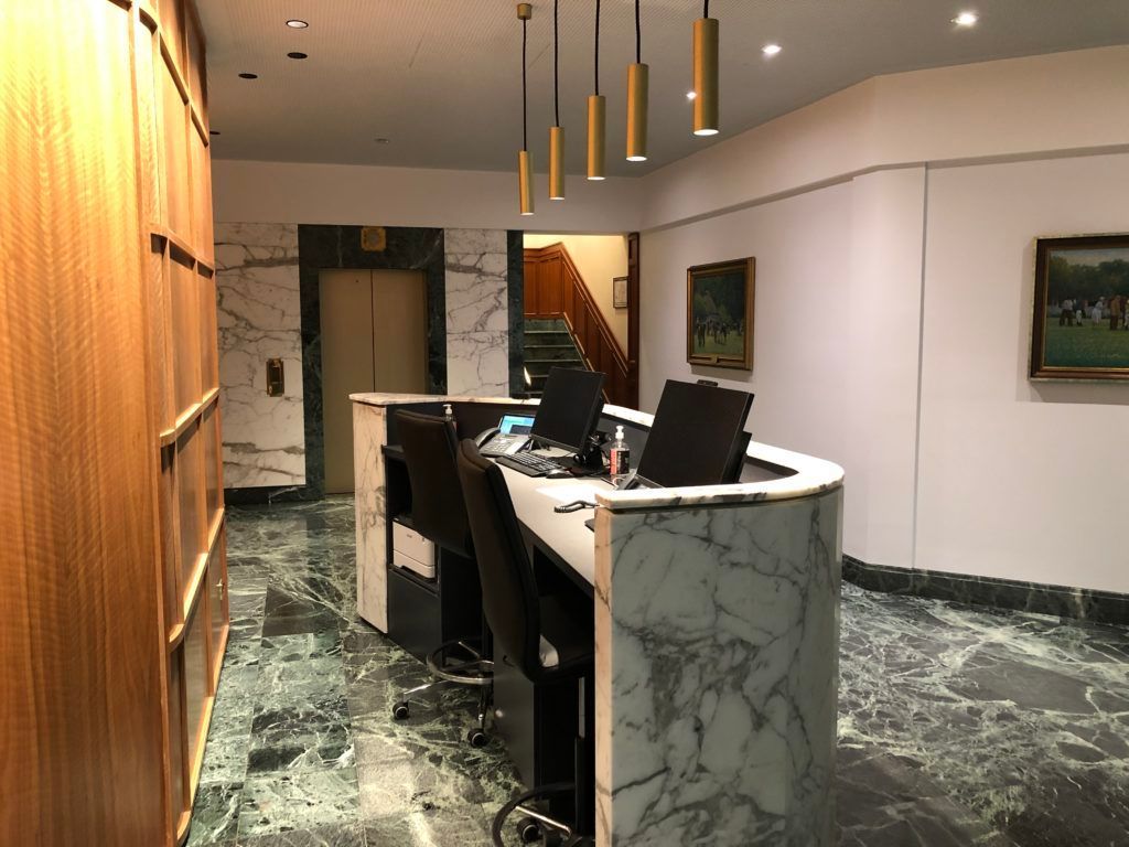 A Hotel Lobby With a Marble Counter and Chairs — JIC Projects Pty Ltd in Runaway Bay, QLD