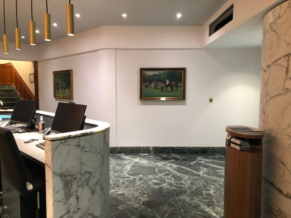 A Reception Area With a Painting on the Wall Above It — JIC Projects Pty Ltd in Runaway Bay, QLD