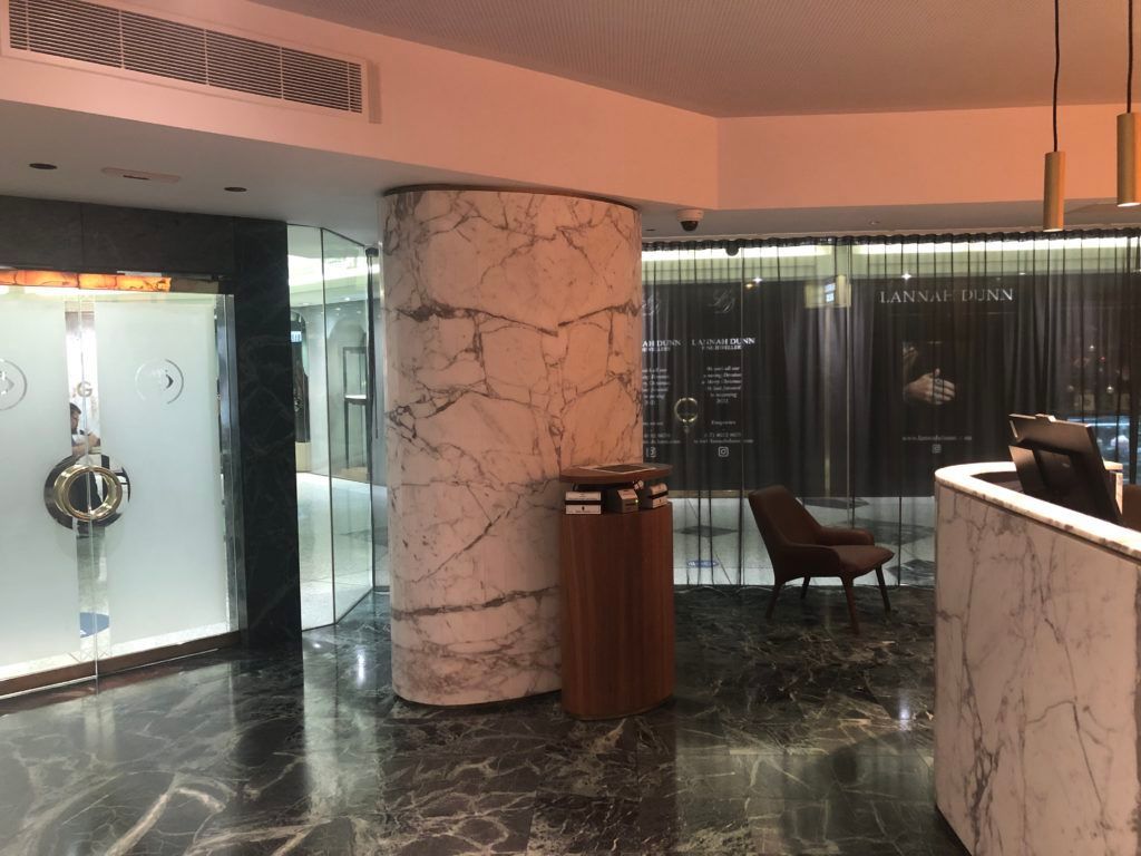 A Lobby of a Hotel With a Marble Counter and Chairs — JIC Projects Pty Ltd in Runaway Bay, QLD