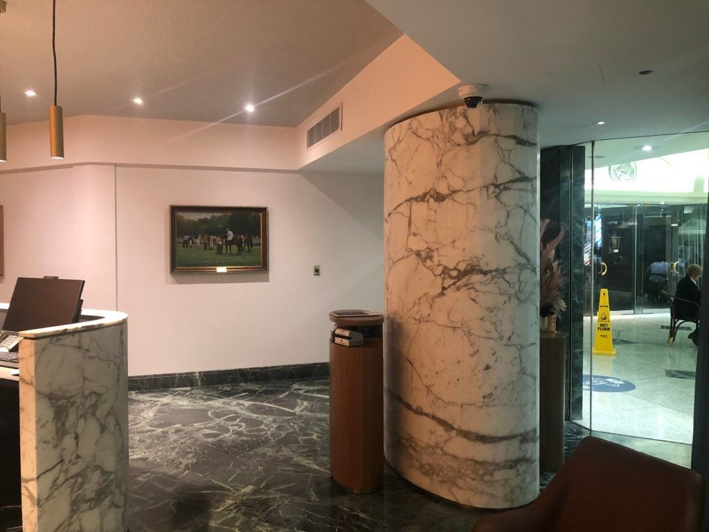 A Lobby With a Marble Pillar and a Picture on the Wall — JIC Projects Pty Ltd in Runaway Bay, QLD