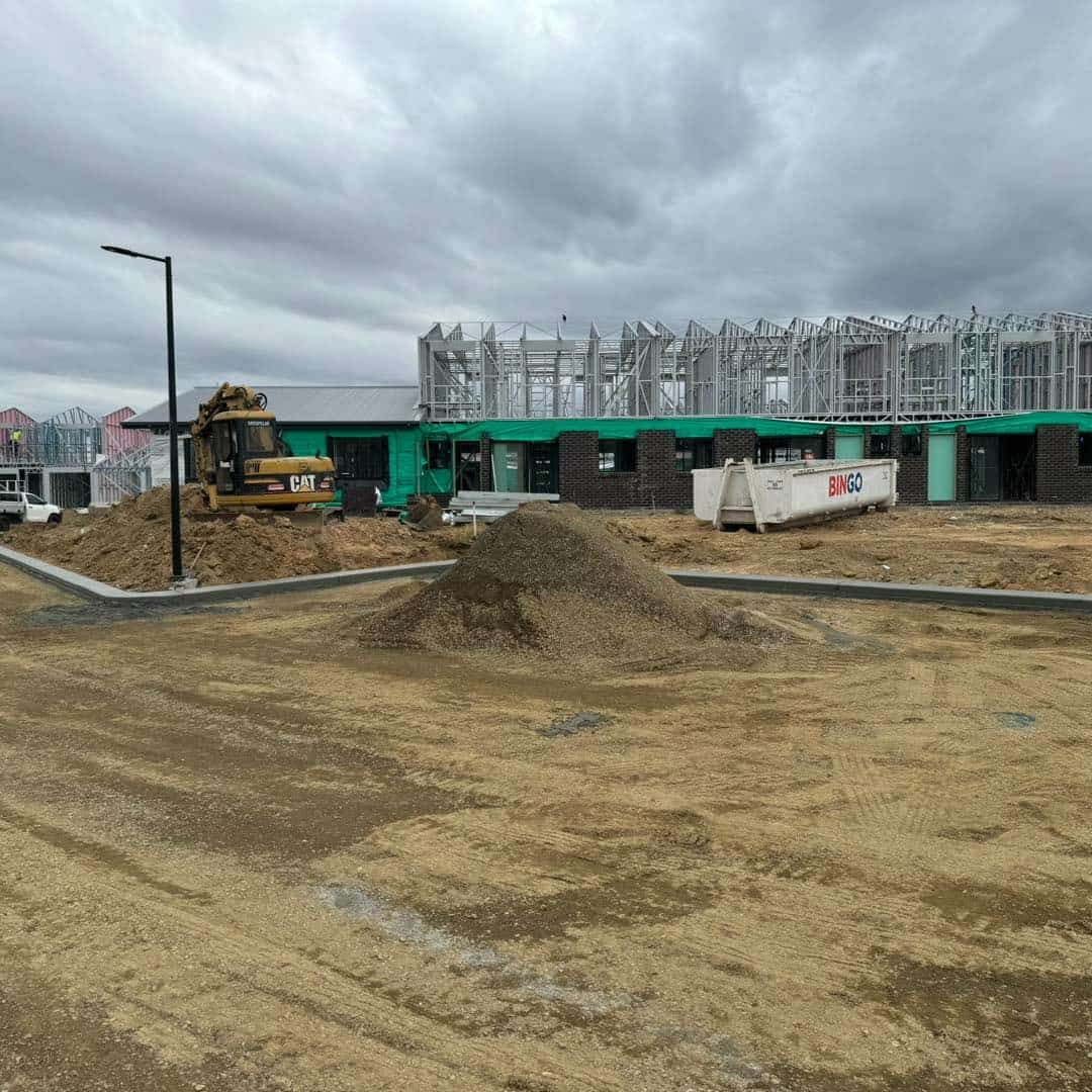 A Construction Site With a Lot of Dirt and a Building in the Background — JIC Projects Pty Ltd in Runaway Bay, QLD