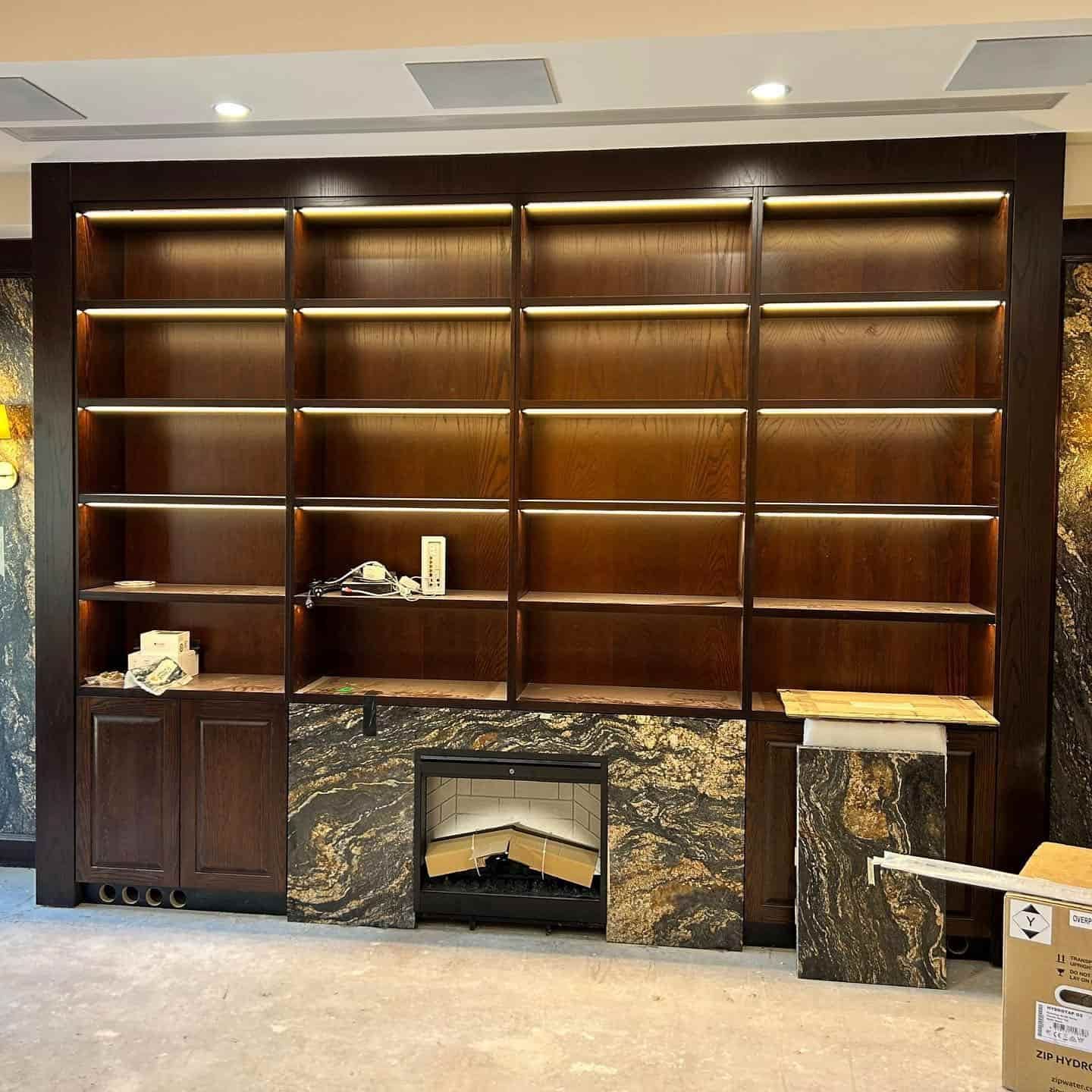 A Living Room With a Fireplace and Shelves — JIC Projects Pty Ltd in Runaway Bay, QLD