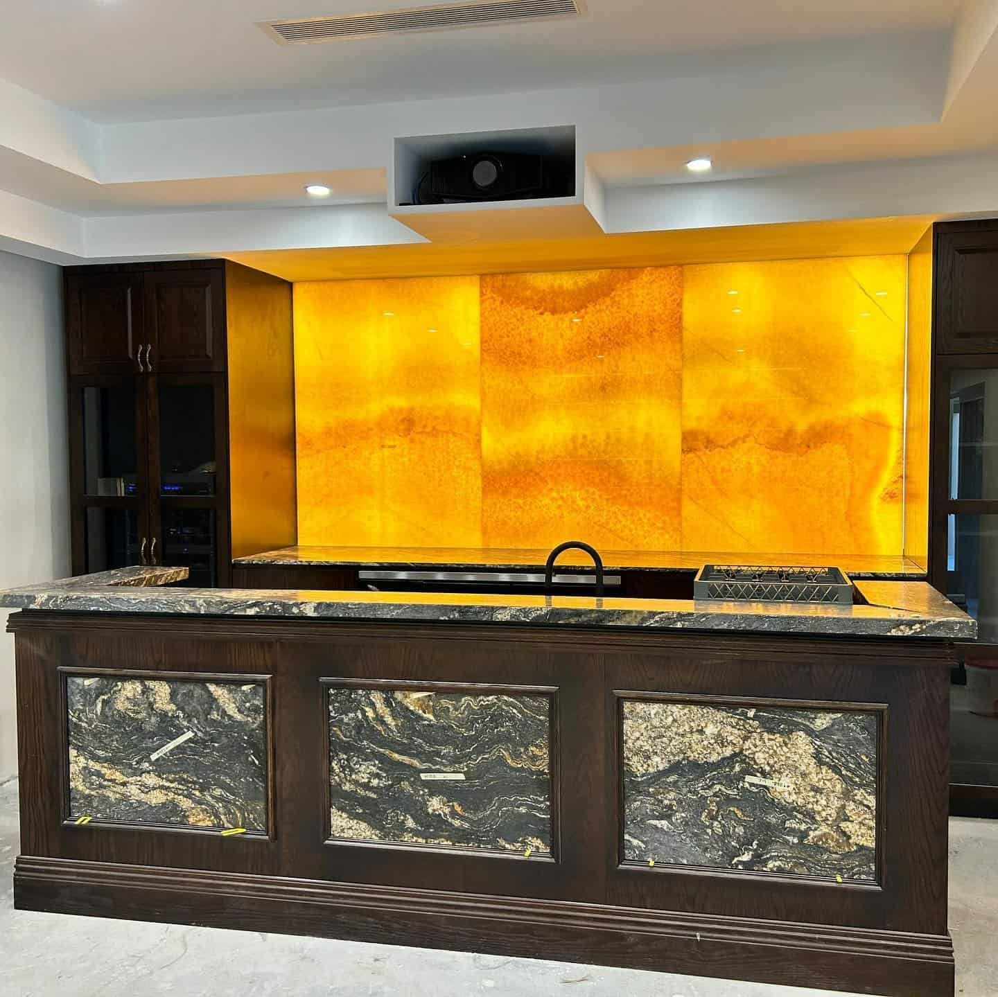 A Kitchen With a Large Island and a Yellow Wall — JIC Projects Pty Ltd in Runaway Bay, QLD