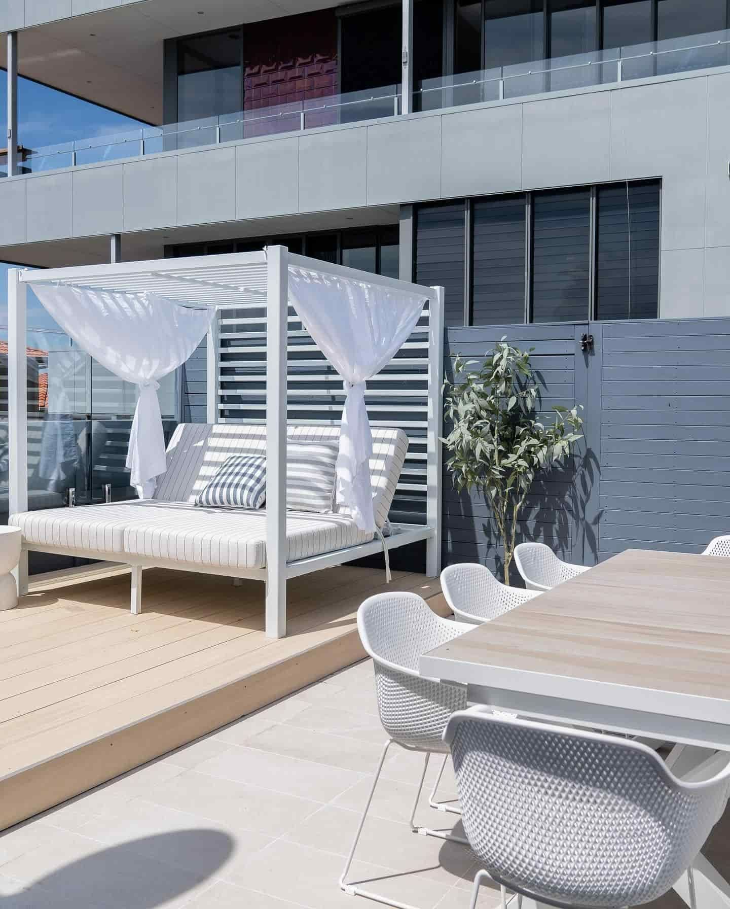 A Patio With a Canopy Bed and a Table and Chairs — JIC Projects Pty Ltd in Runaway Bay, QLD
