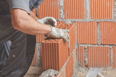Construction Worker Bricklaying The Wall Indoors - Allen, TX - Alpha Foundation Repair LLC