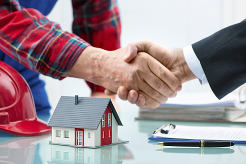 Contractor & Man in Suit Shake Hands over Home Appraisal