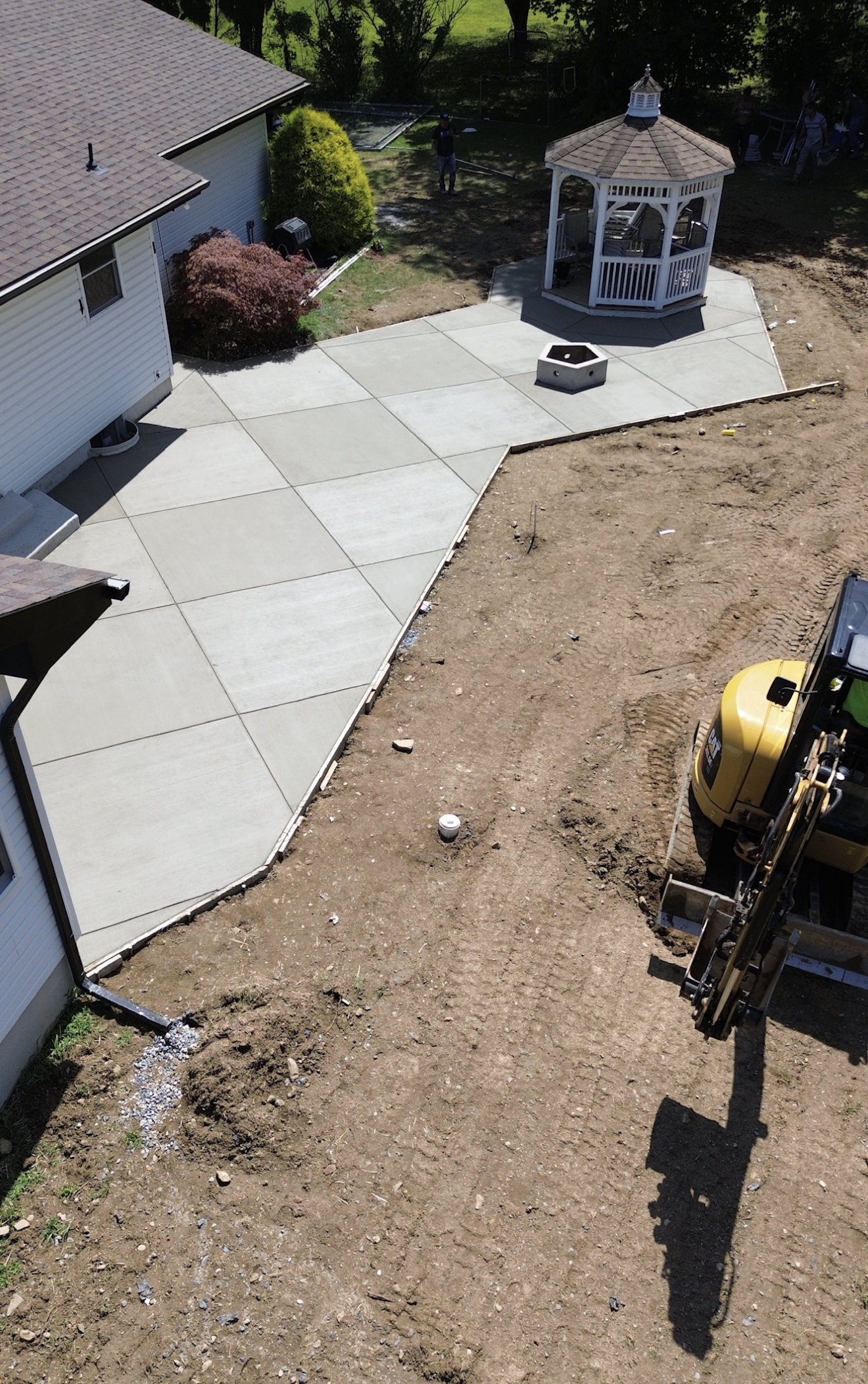 An aerial view of a house and a gazebo being built.