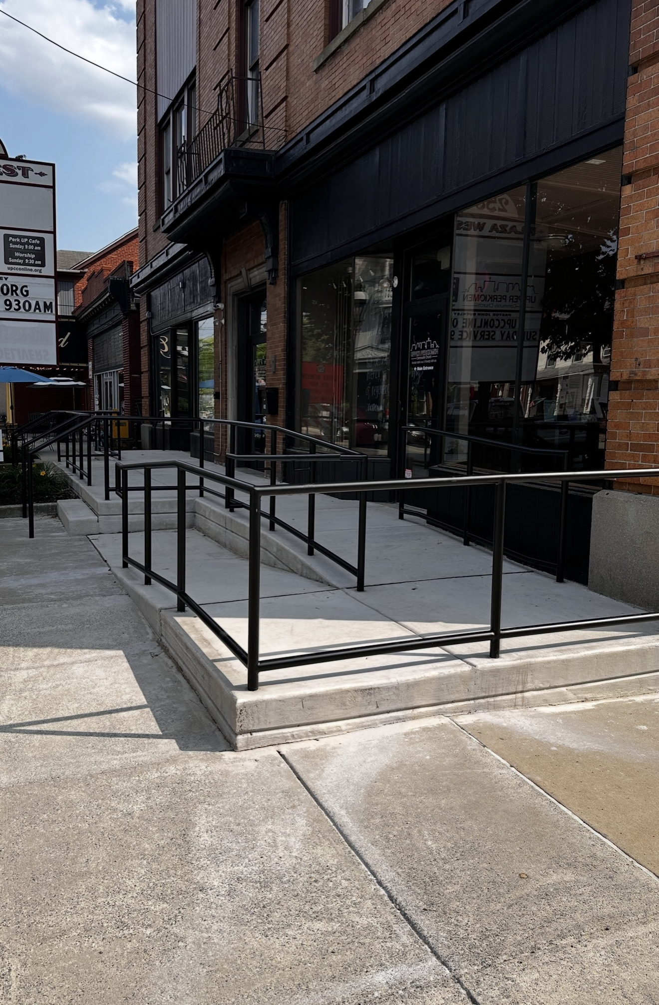 There is a ramp leading to the front of a building.