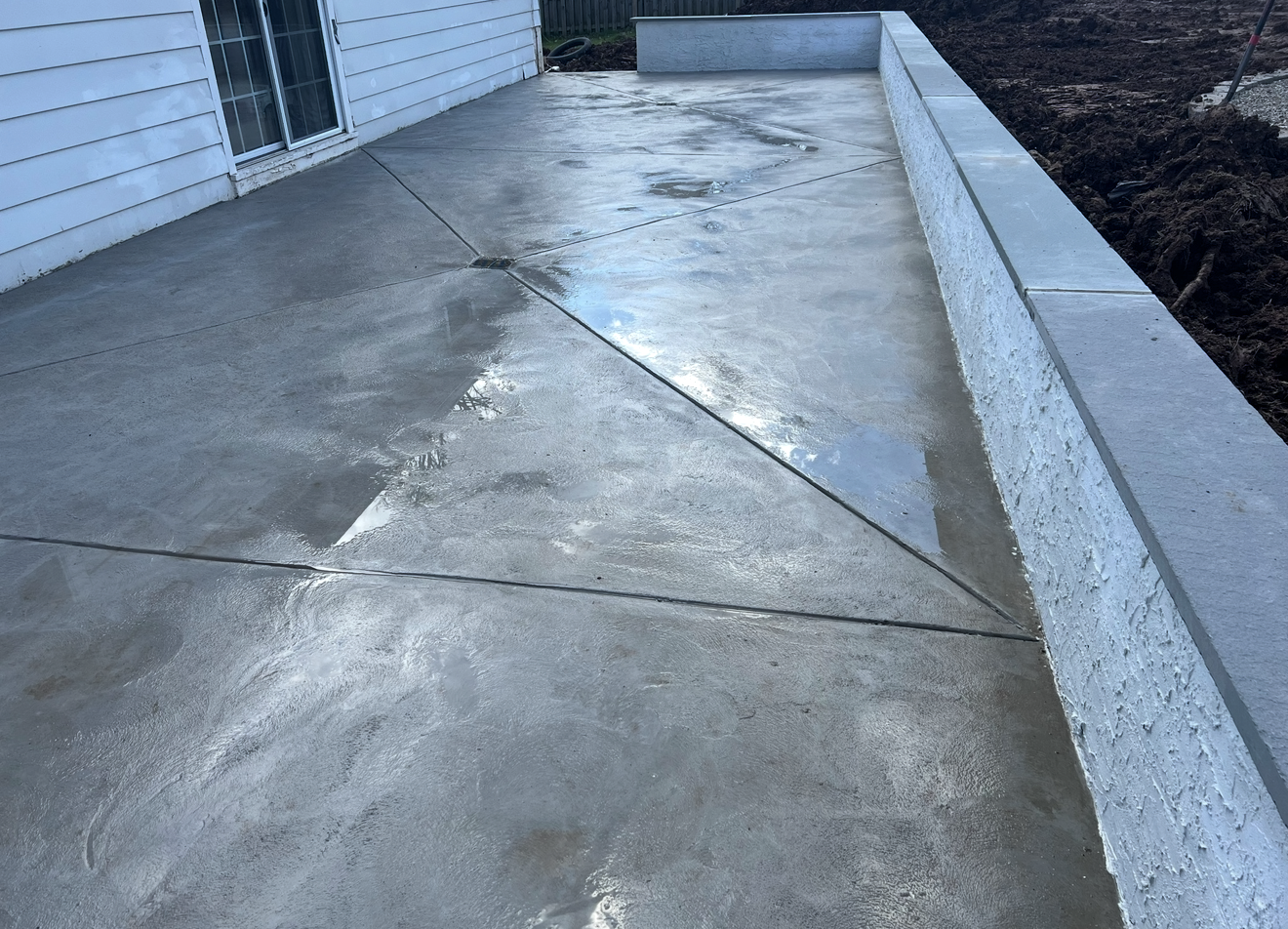 A concrete walkway in front of a white house