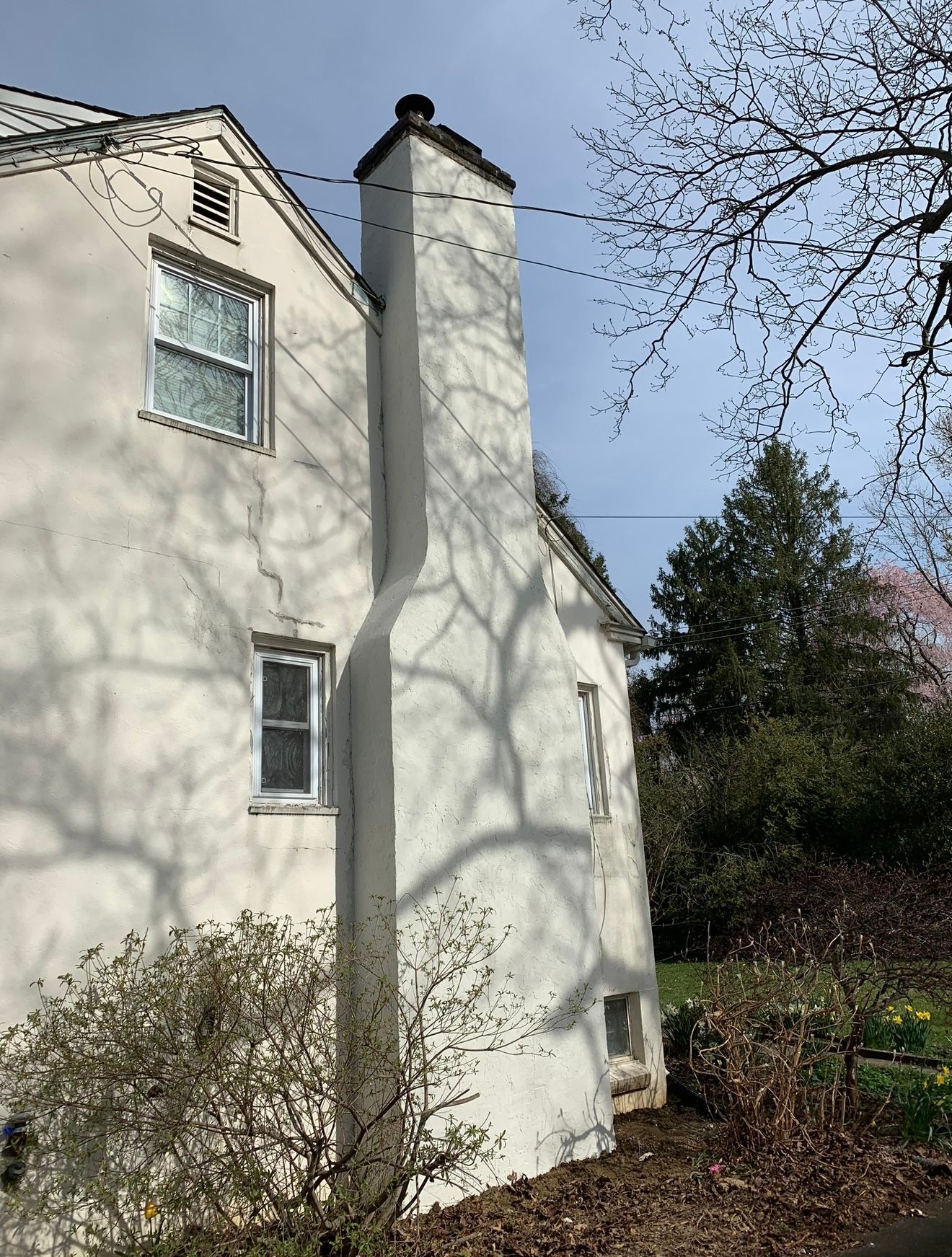 A concrete patio in front of a house with a sunset in the background.