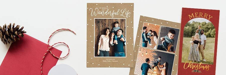 A variety of holiday and Christmas Cards on a grey table top.