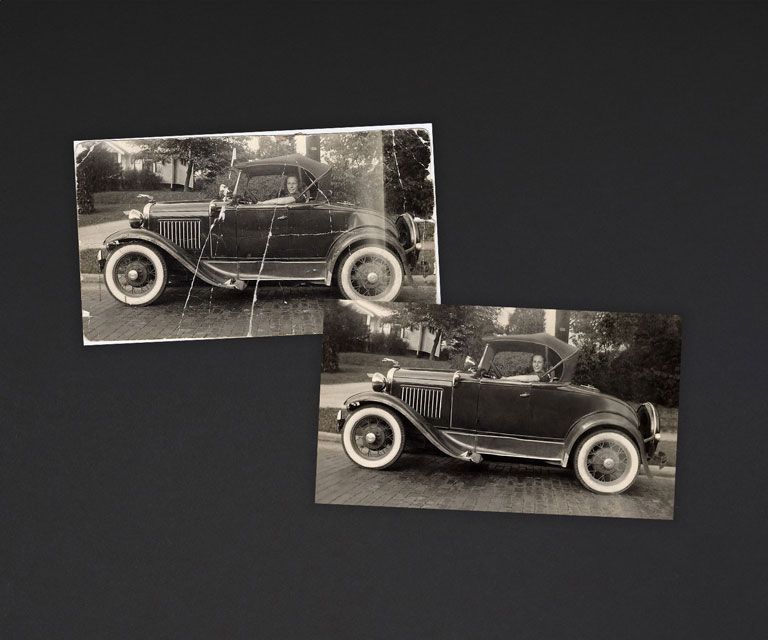 A cup of coffee sits on a table surrounded by  old black and white pictures of various people and landmarks. There are visible drops of coffee spilled on the table, with a few captured in media res frozen in mid air.