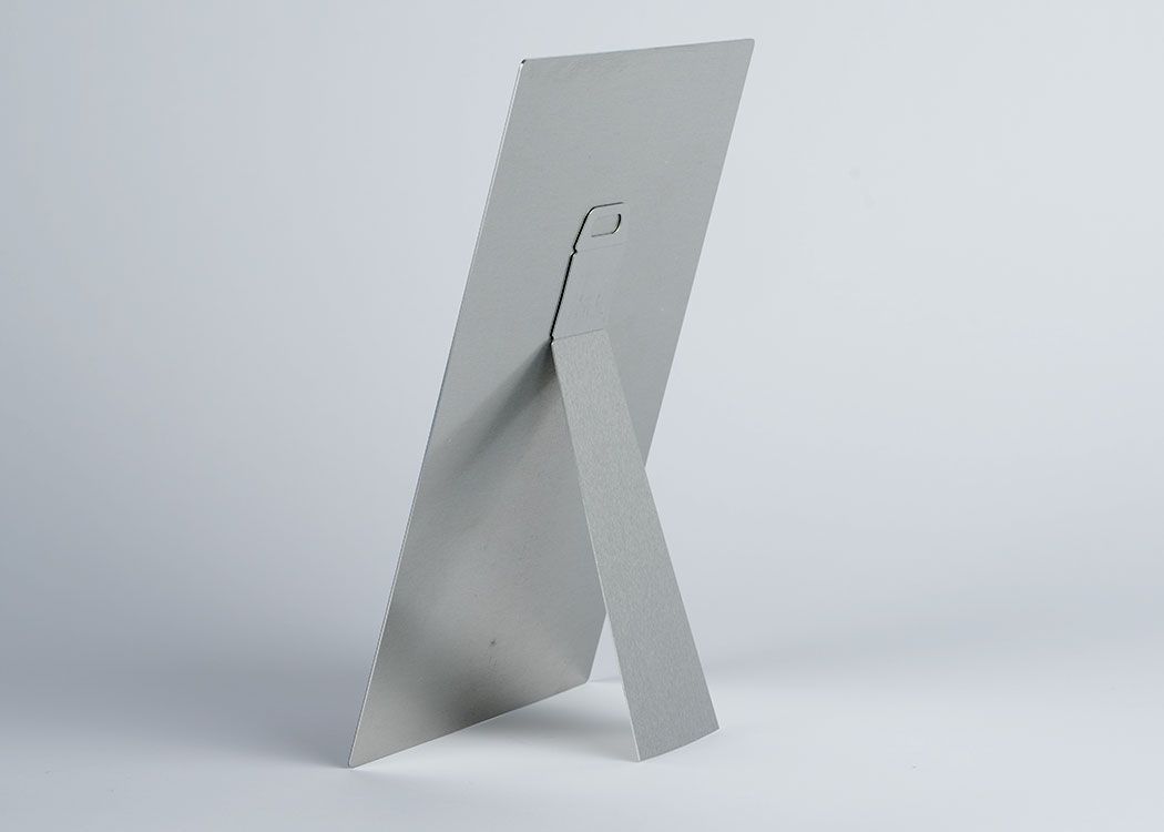 The backside of a metal print showing off the metal easel option.