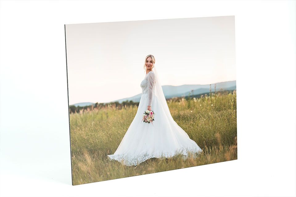 The presentation print shows a beautiful bride with a long dress standing in a field.