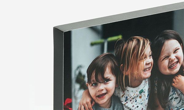 A picture of children laughing mounted on thin edge 3/4