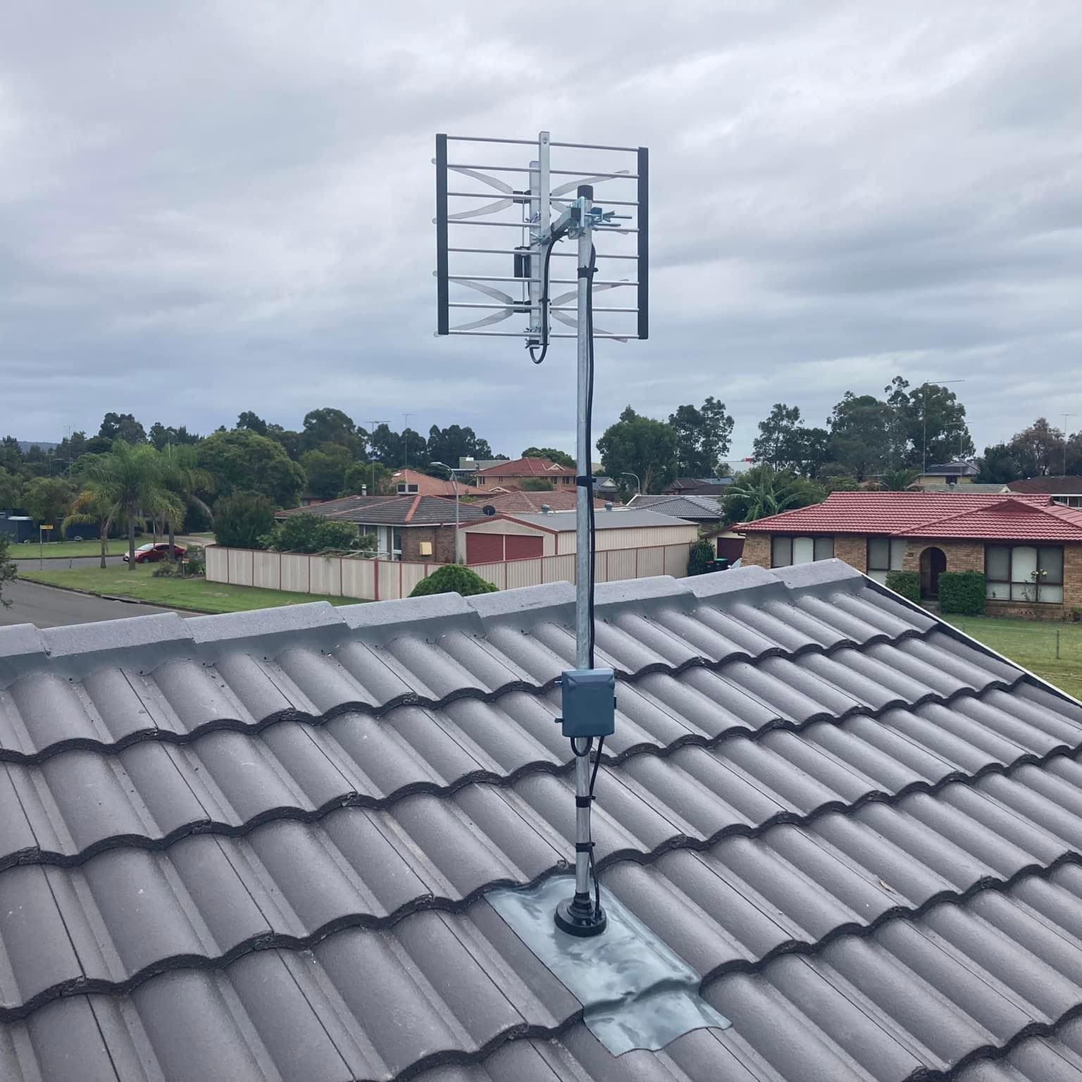 TV Antenna Mounted on a Tiled Roof, Overcast Sky in Background — Wide Area Communications in Hawkesbury, NSW