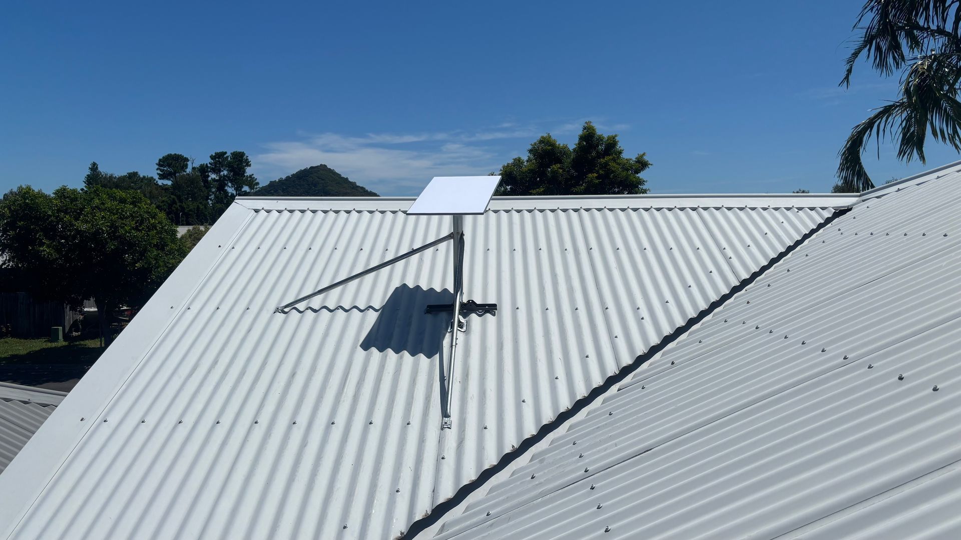 White Satellite Dish on a Metal Roof — Wide Area Communications in Hawkesbury, NSW