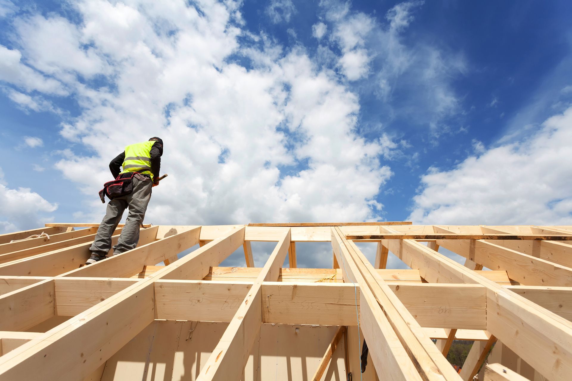 A man is standing on top of a wooden structure.
