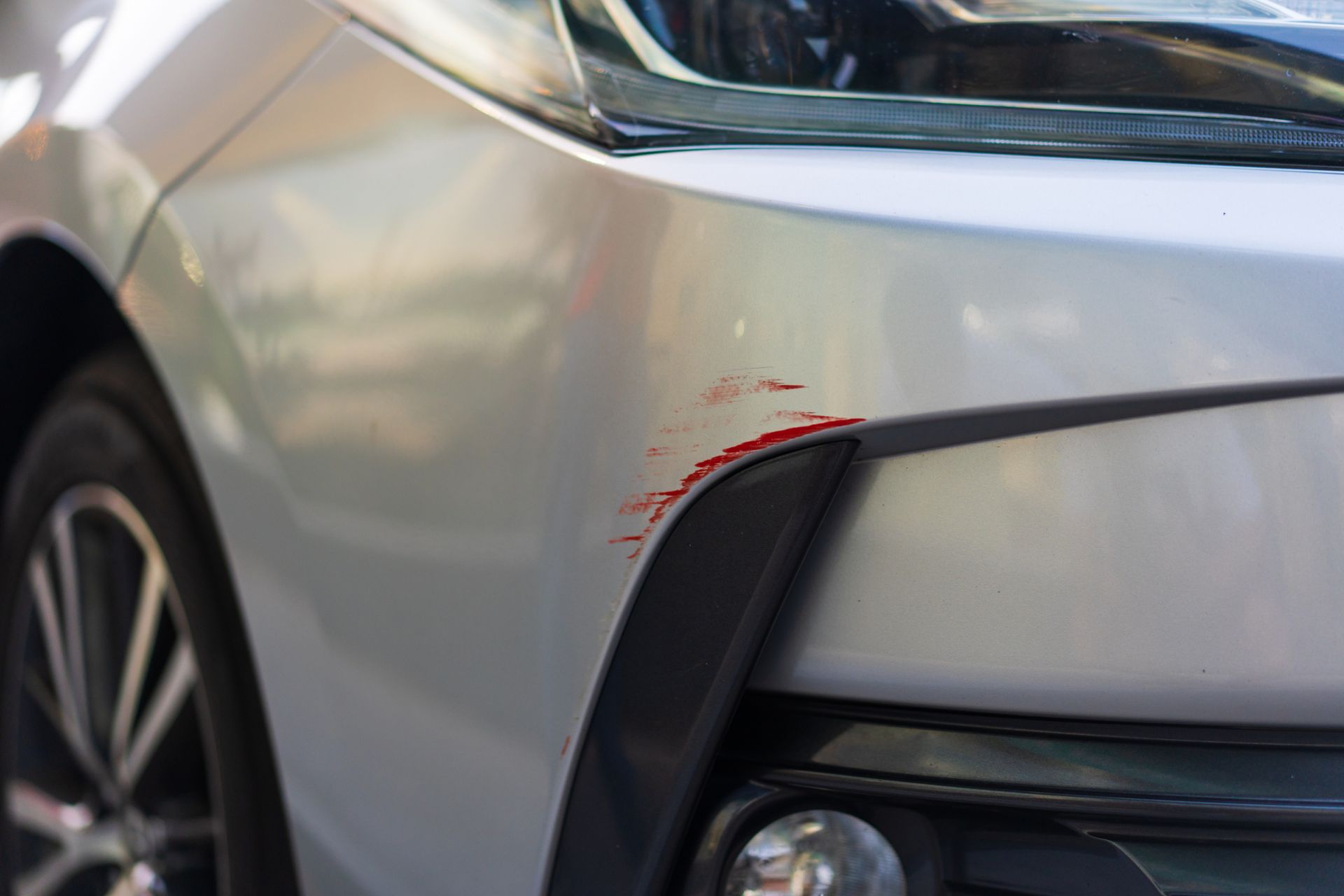 Small scratch on a car front bumper.