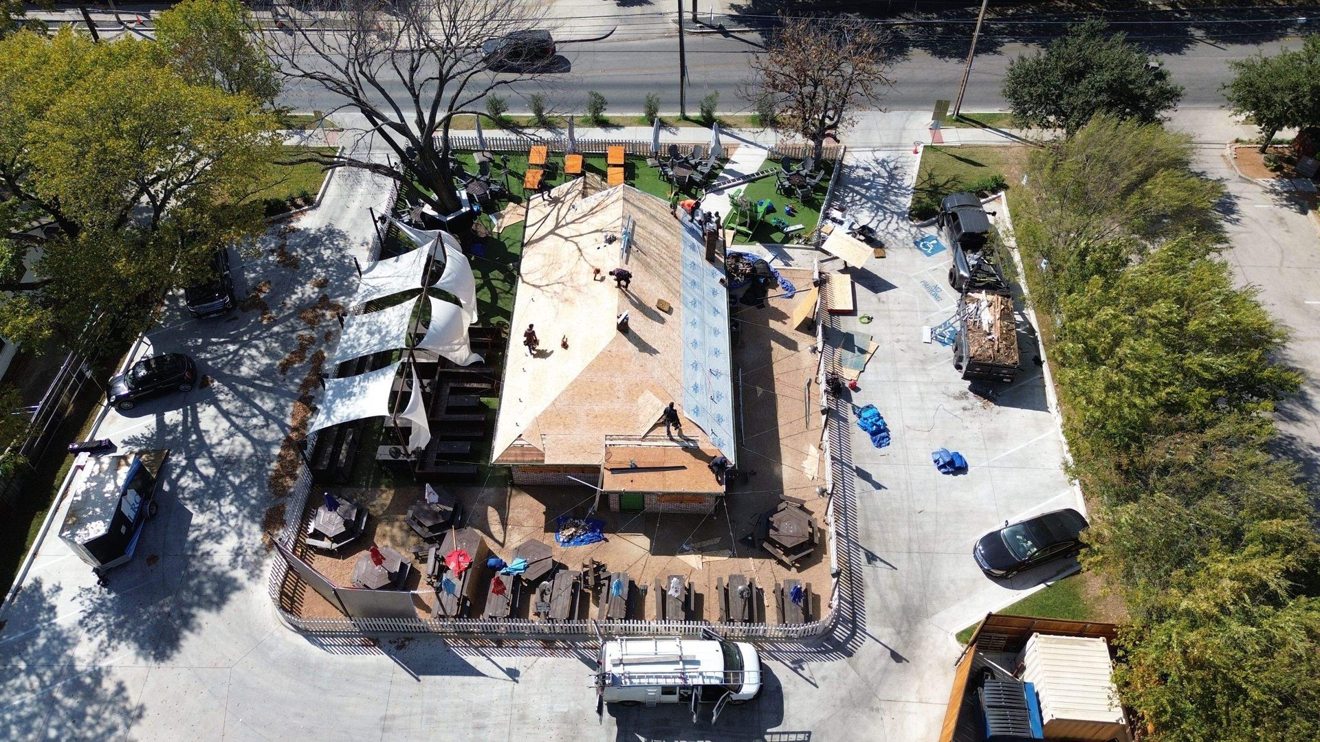 An aerial view of a building under construction in a parking lot