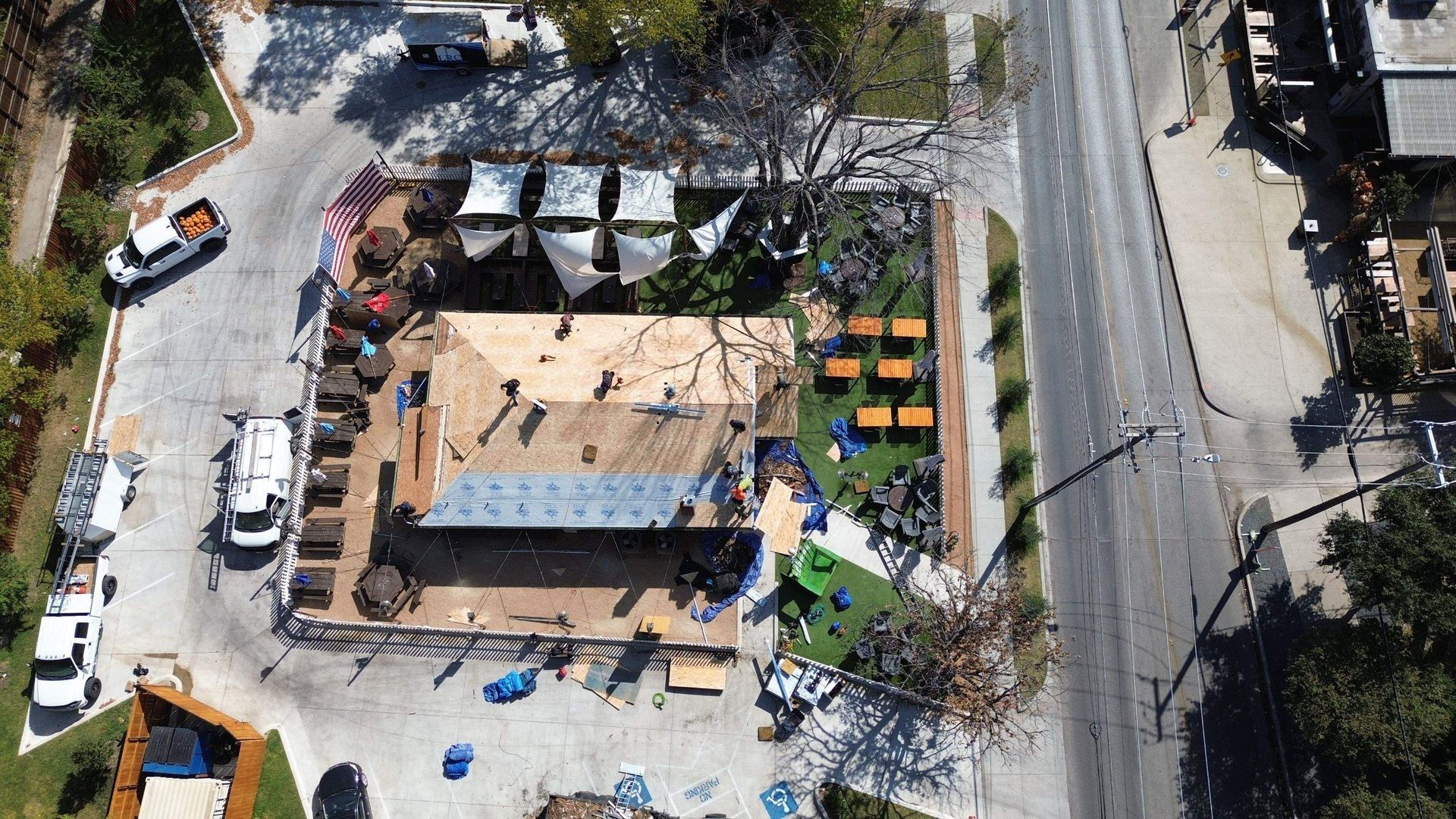 An aerial view of a building under construction in a parking lot.