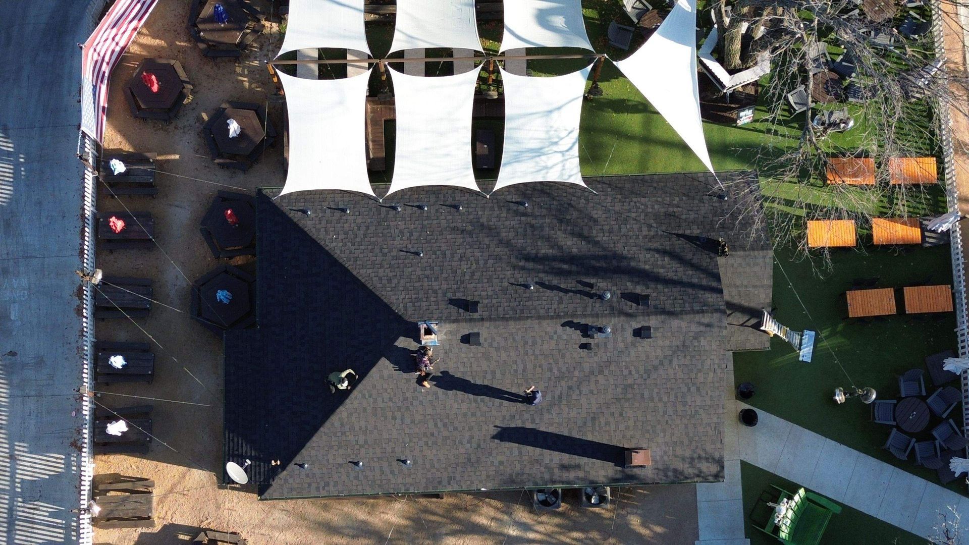 An aerial view of a building with a lot of tables and chairs