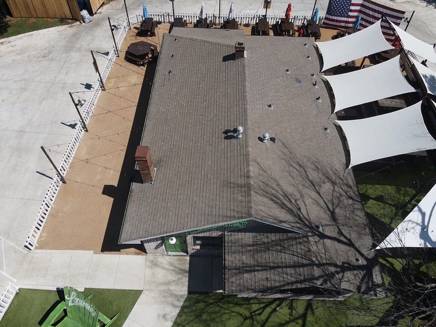 An aerial view of a house with a roof that is covered in shingles