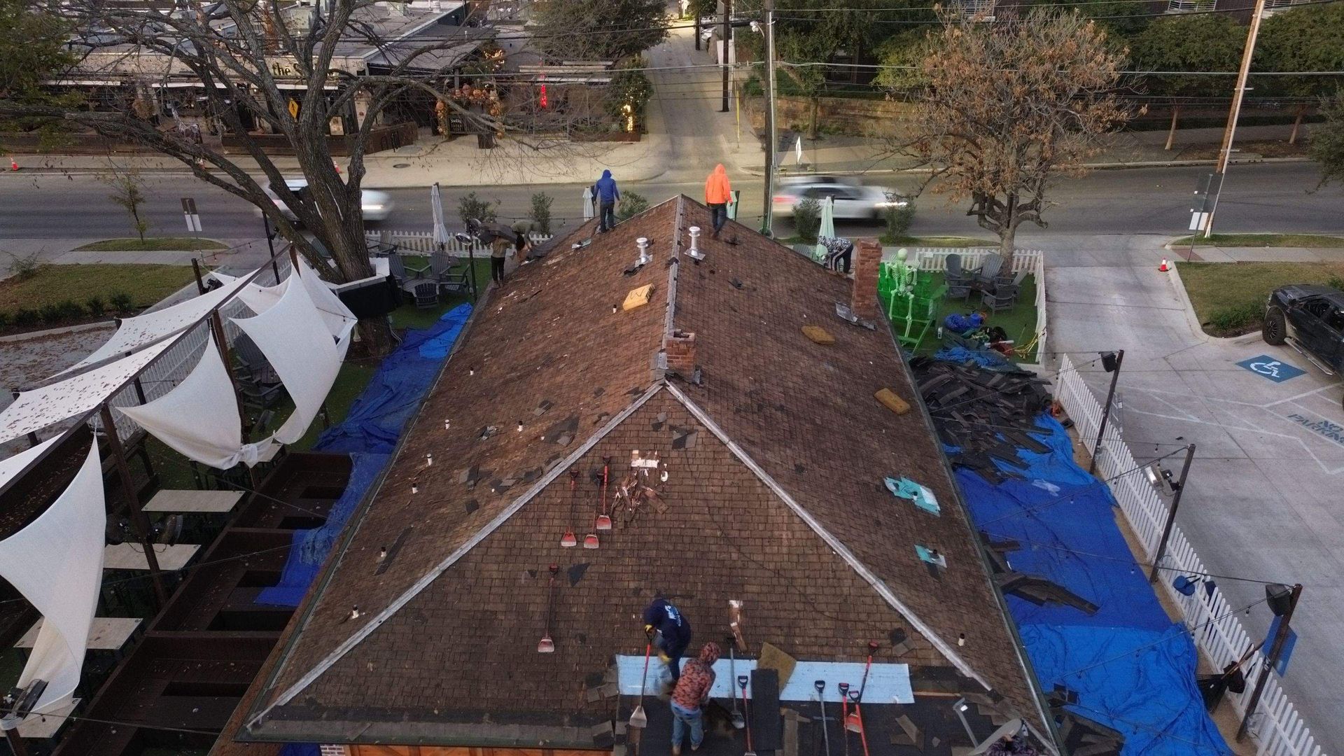 An aerial view of a roof that is being repaired.