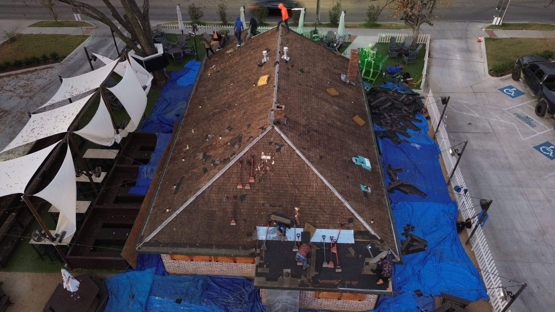 An aerial view of a roof that is being repaired.