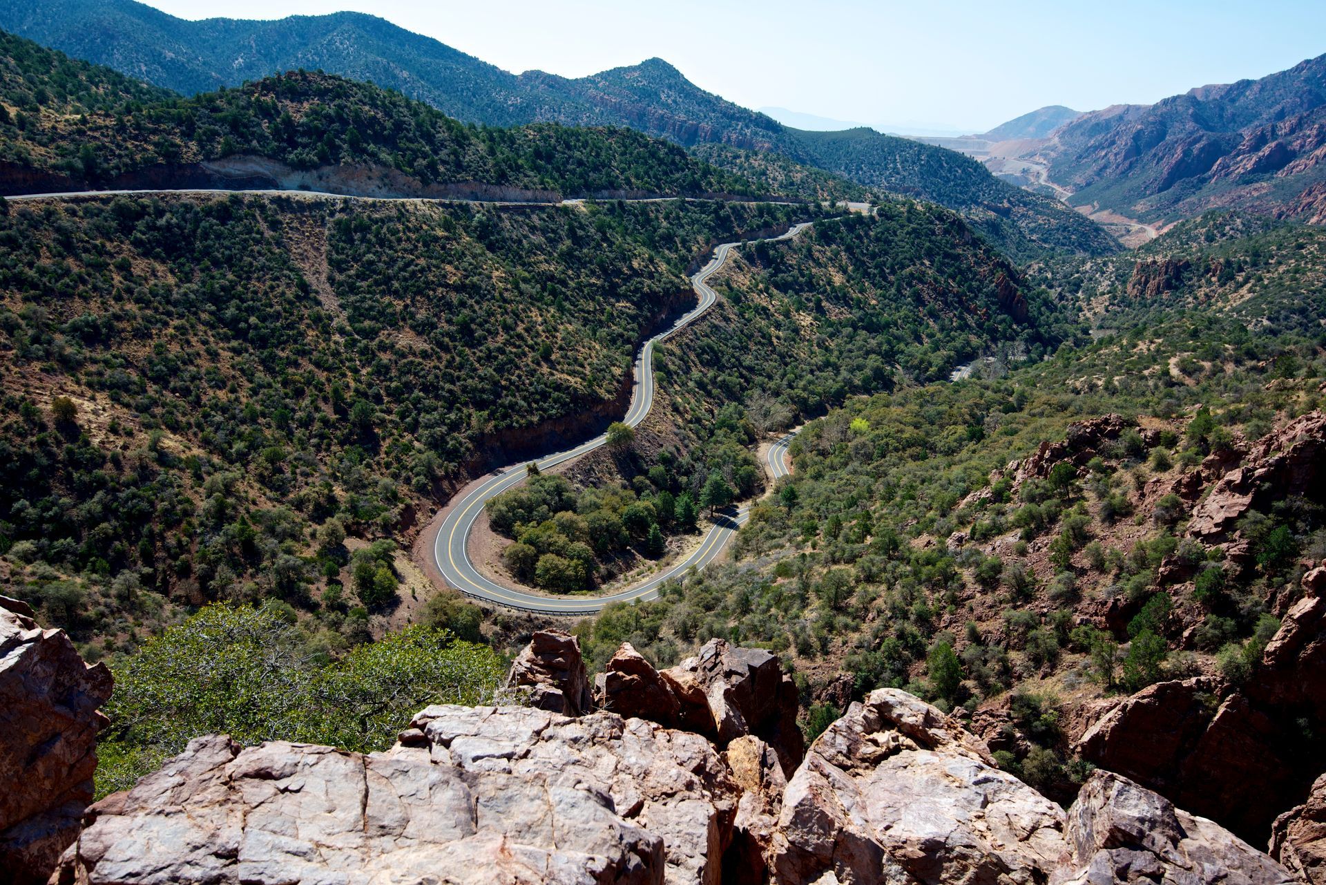 A view of a mountain valley with a road going through it