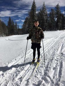 A man is standing on skis in the snow.