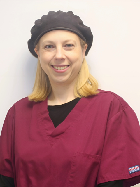 A stethoscope is laying on a piece of paper next to a pen