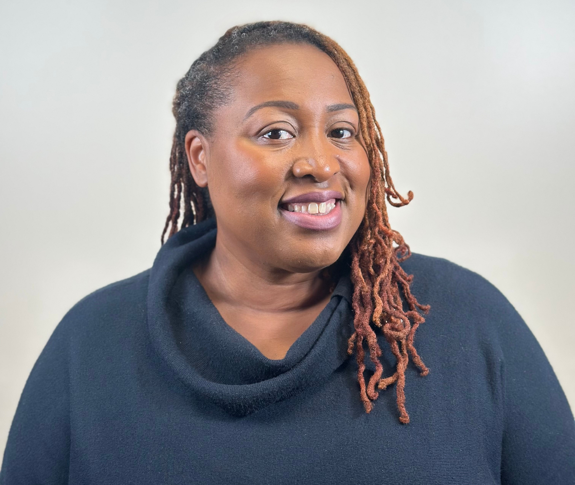 A stethoscope is laying on a piece of paper next to a pen