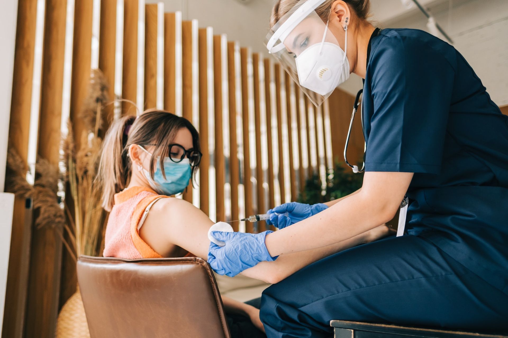 A nurse is giving a child a vaccine.