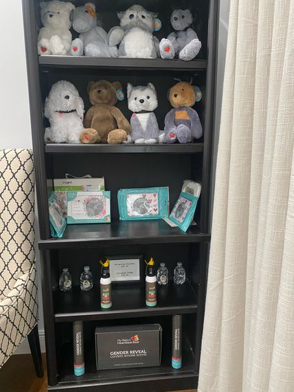 A bookshelf filled with stuffed animals and bottles.