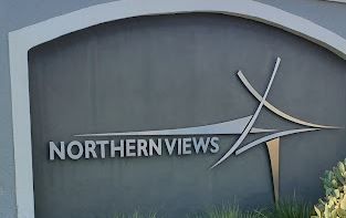 A sign for northern views is on the side of a building.